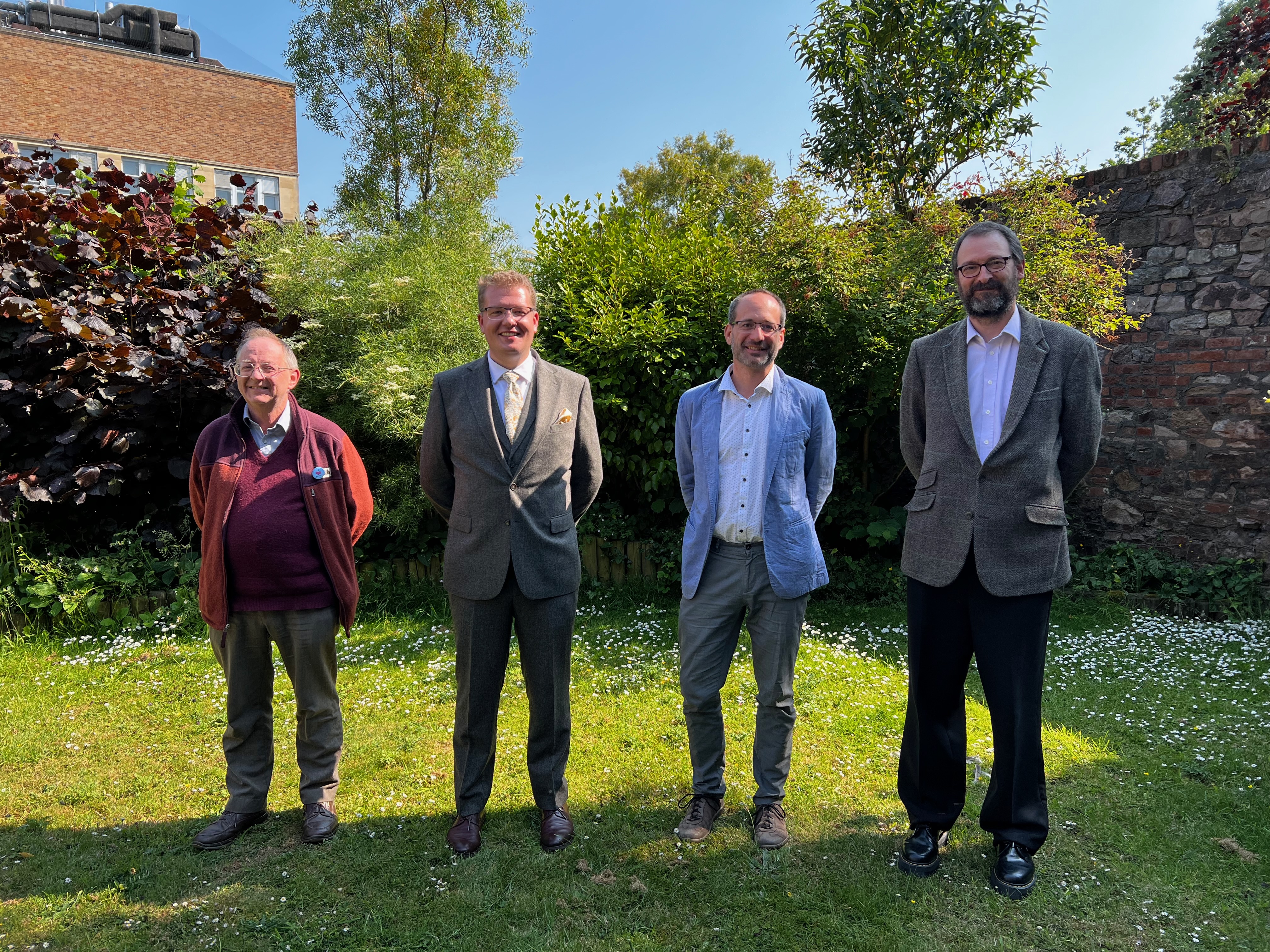 Stanisław in a garden with PhD examiners